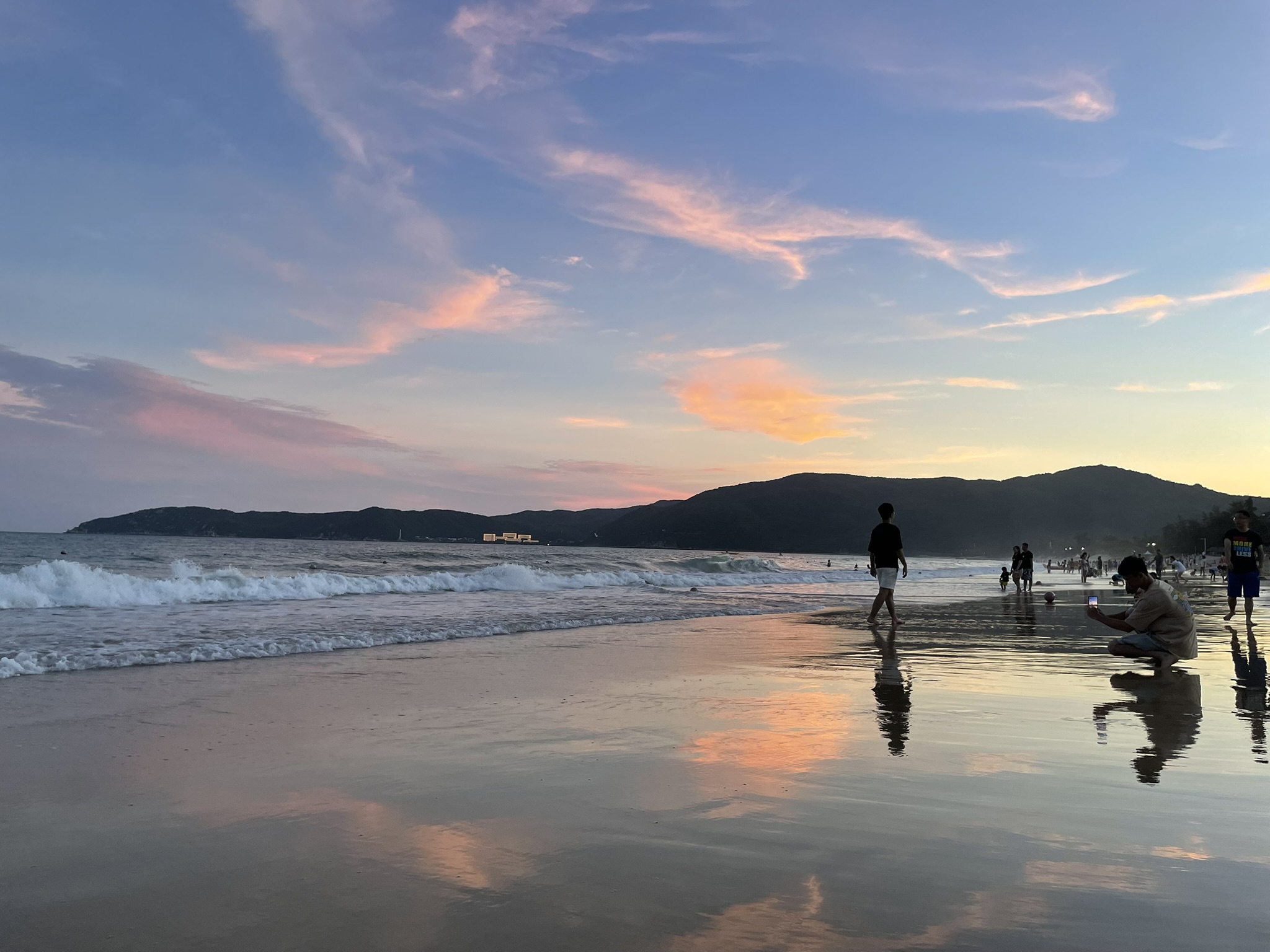 Turquoise waters and palm-lined shore at Yalong Bay in Sanya, China.