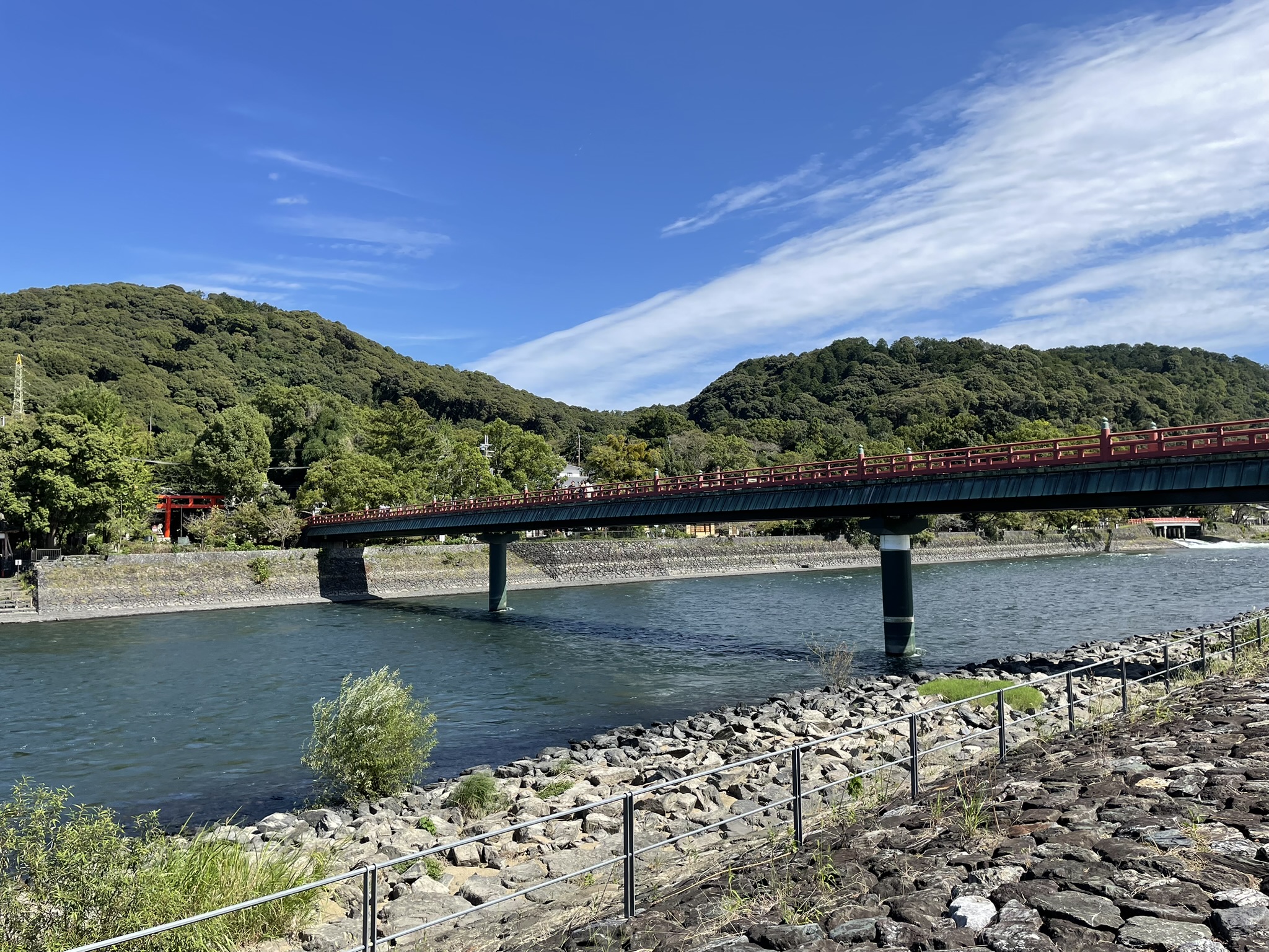 Gentle flow of Uji River framed by greenery in Uji, Japan.